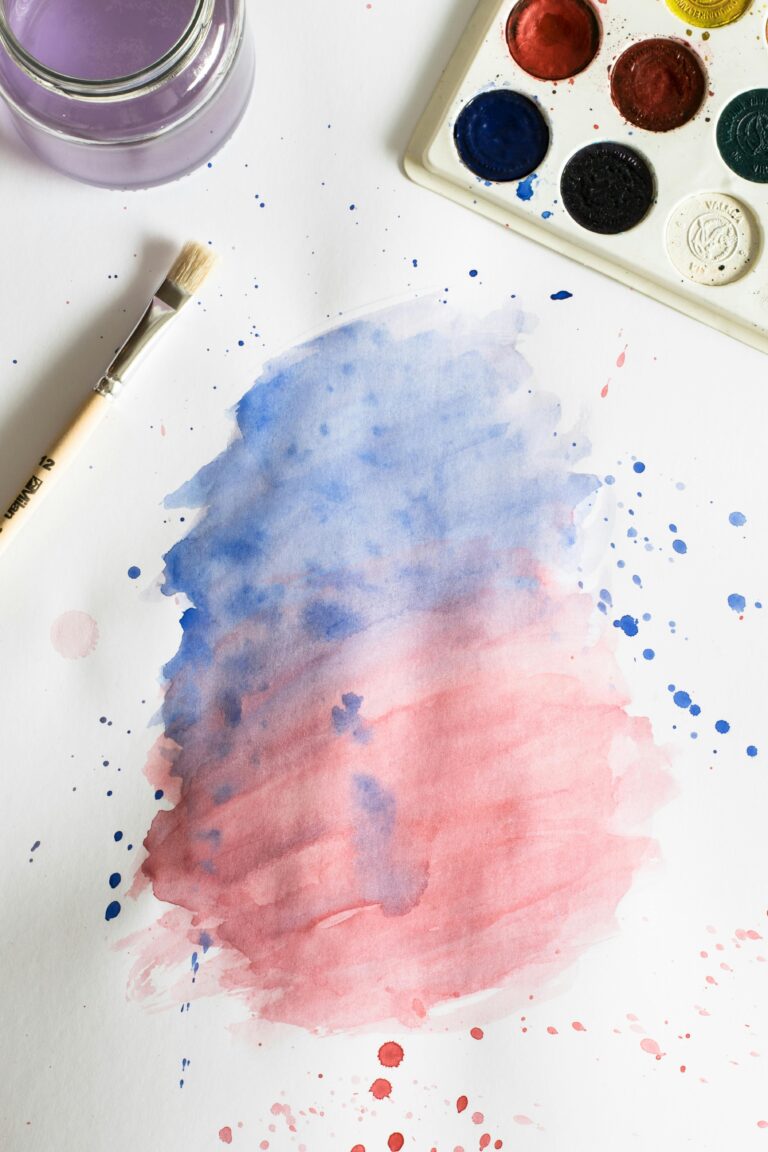 Vibrant watercolor painting with blue and red gradient, brush, and palette.